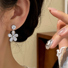 Model showcasing the dangle and style of the 14K Gold-Plated Zircon Diamond Flower Tassel Earrings