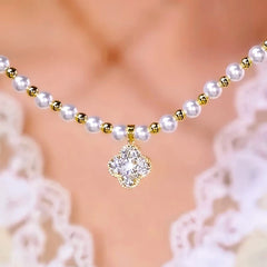 Close-up of the pendant and clasp on the Clover Pearl Necklace