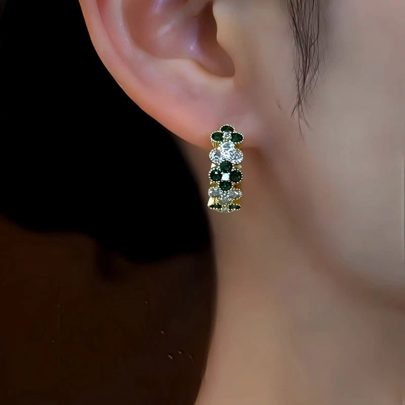 Model showcasing the dangle and style of the 14K Gold-Plated Zircon Diamond Four-Leaf Flower Hoop Earrings