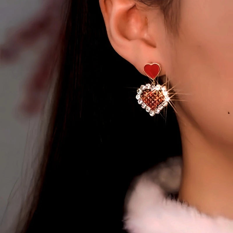Close-up detail of the sparkling zircons and plating on the Red Heart Dangle Earrings