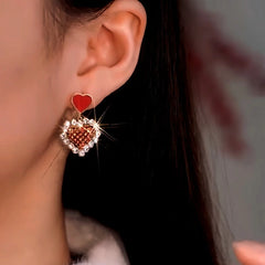 Model showcasing the dangle and style of the 14K Gold-Plated Zircon Diamond Heart Earrings