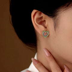 Model showcasing the dangle and style of the 14K Gold-Plated Zircon Diamond Heart Stud Earrings