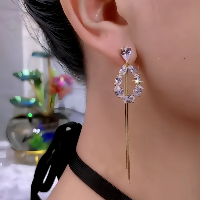 Model showcasing the dangle and style of the 14K Gold-Plated Zircon Diamond Heart Tassel Earrings