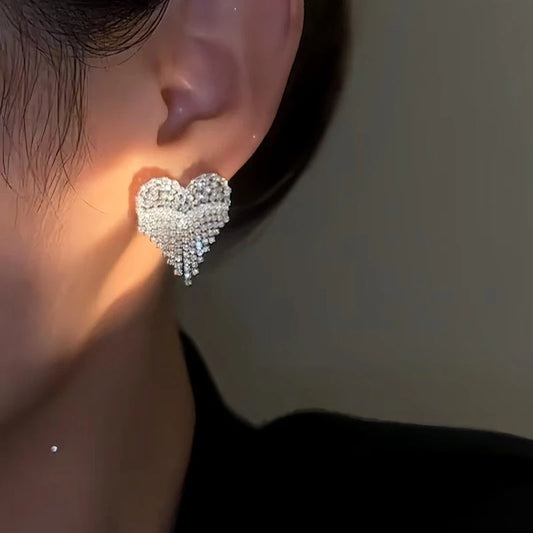 Model showcasing the dangle and style of the 14K Gold-Plated Zircon Diamond Heart Tassel Earrings