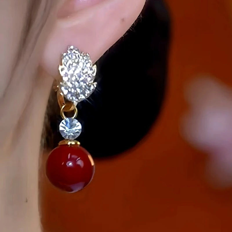 Model showcasing the dangle and style of the 14K Gold-Plated Zircon Diamond Jade Leaf Bead Earrings