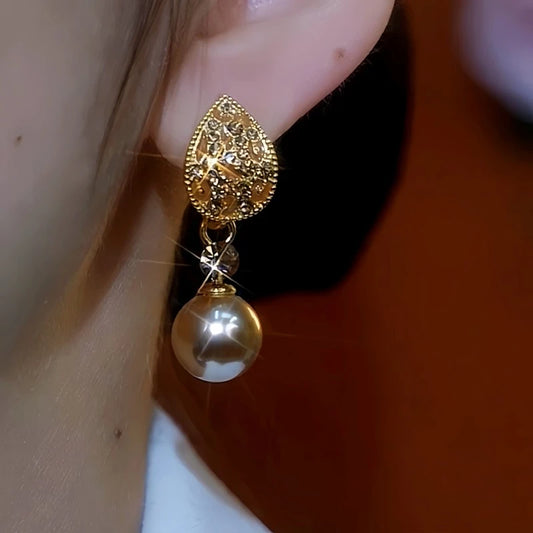 Model showcasing the dangle and style of the 14K Gold-Plated Zircon Diamond Leaf Pearl Earrings