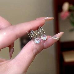 Model showcasing the dangle and style of the 14K Gold-Plated Zircon Diamond Little Hoop Earrings