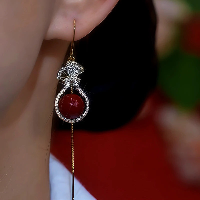 Model showcasing the dangle and style of the 14K Gold-Plated Zircon Diamond Lucky Bag Pearl Threader Earrings