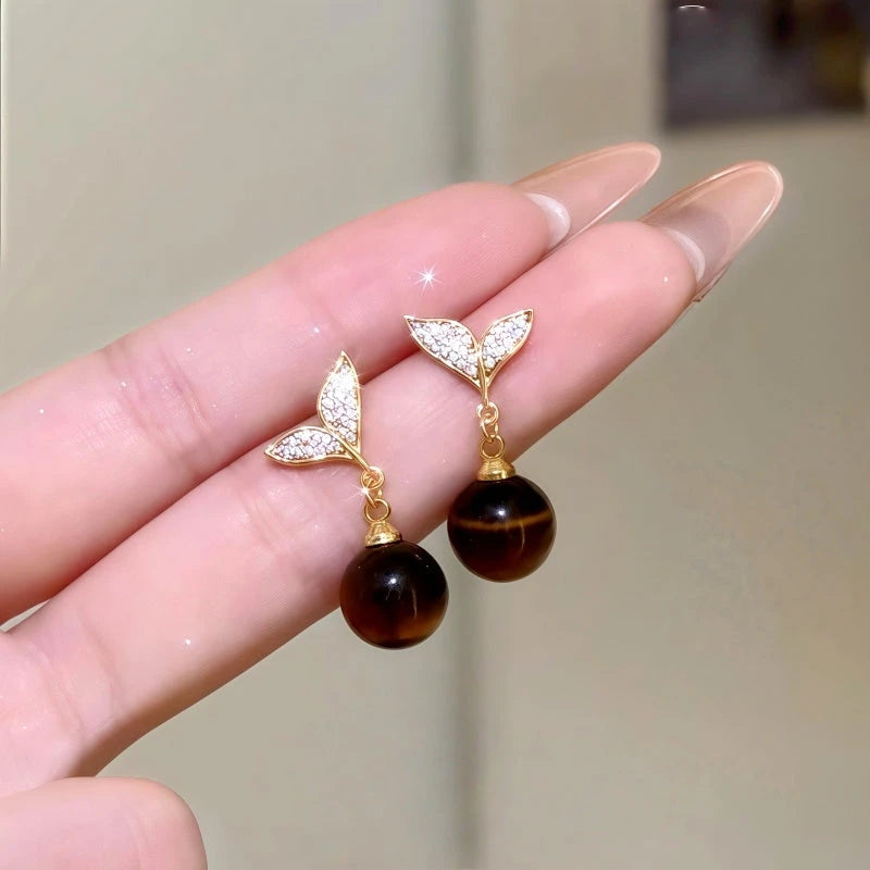Close-up detail of the sparkling zircons and plating on the Mermaid Tail Earrings