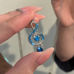 Close-up of the pendant and clasp on the Musical Note Necklace