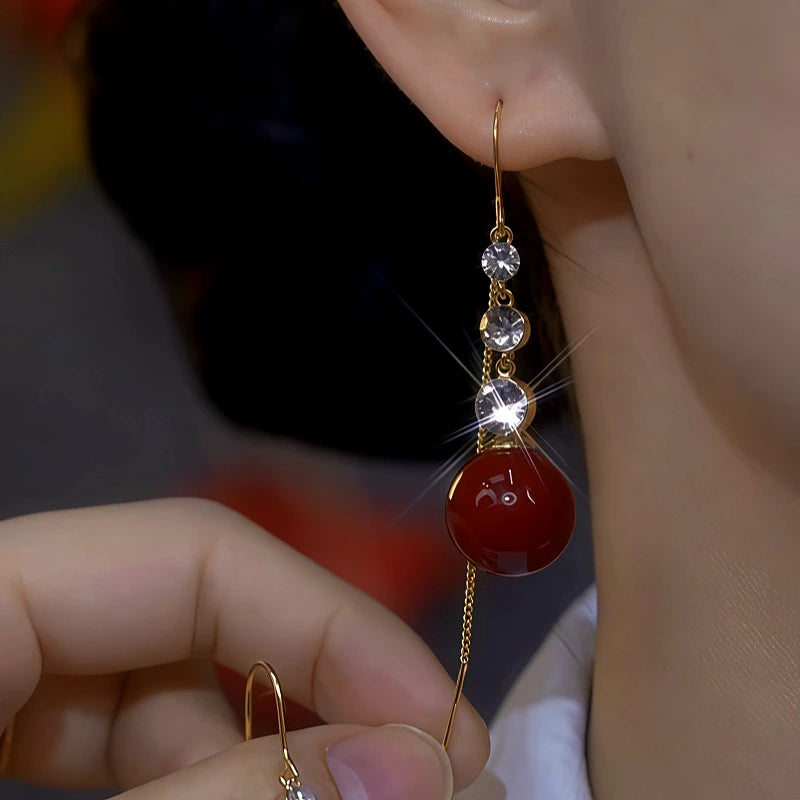 Model showcasing the dangle and style of the 14K Gold-Plated Zircon Diamond Pearl Earrings