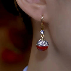 Model showcasing the dangle and style of the 14K Gold-Plated Zircon Diamond Pearl Earrings