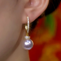 Close-up detail of the sparkling zircons and plating on the Pearl Drop Earrings