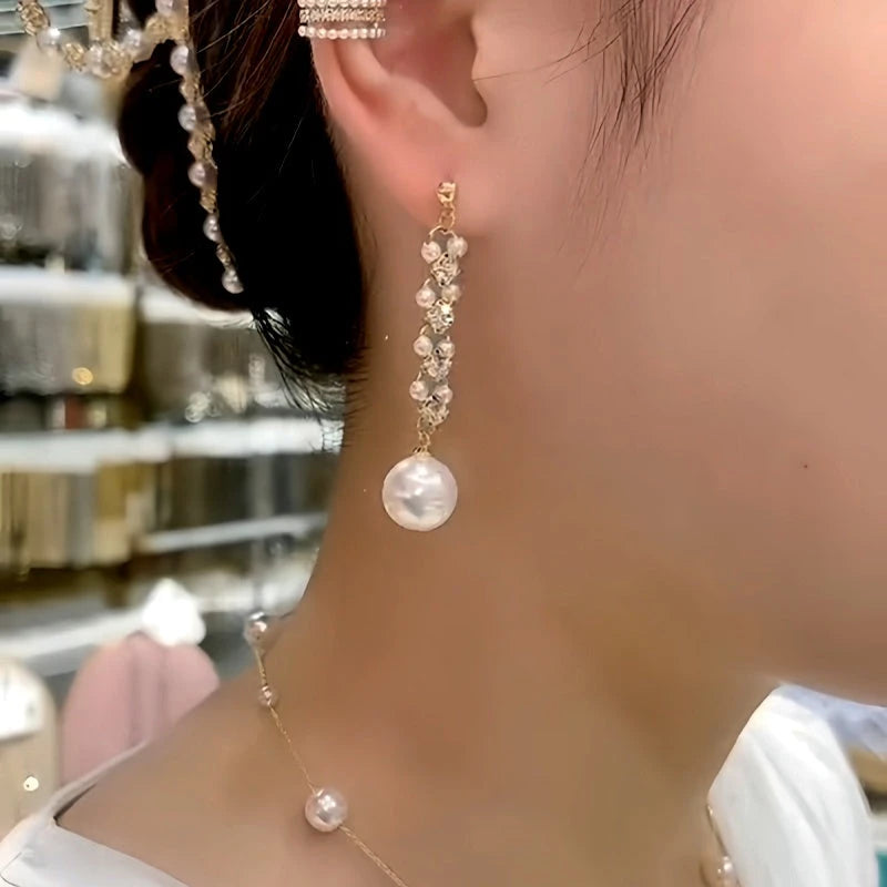 Model showcasing the dangle and style of the 14K Gold-Plated Zircon Diamond Pearl Earrings