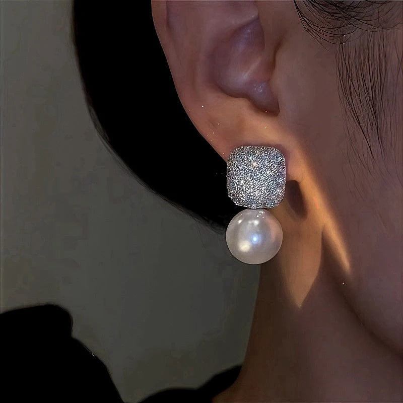Model showcasing the dangle and style of the 14K Gold-Plated Zircon Diamond Pearl Earrings