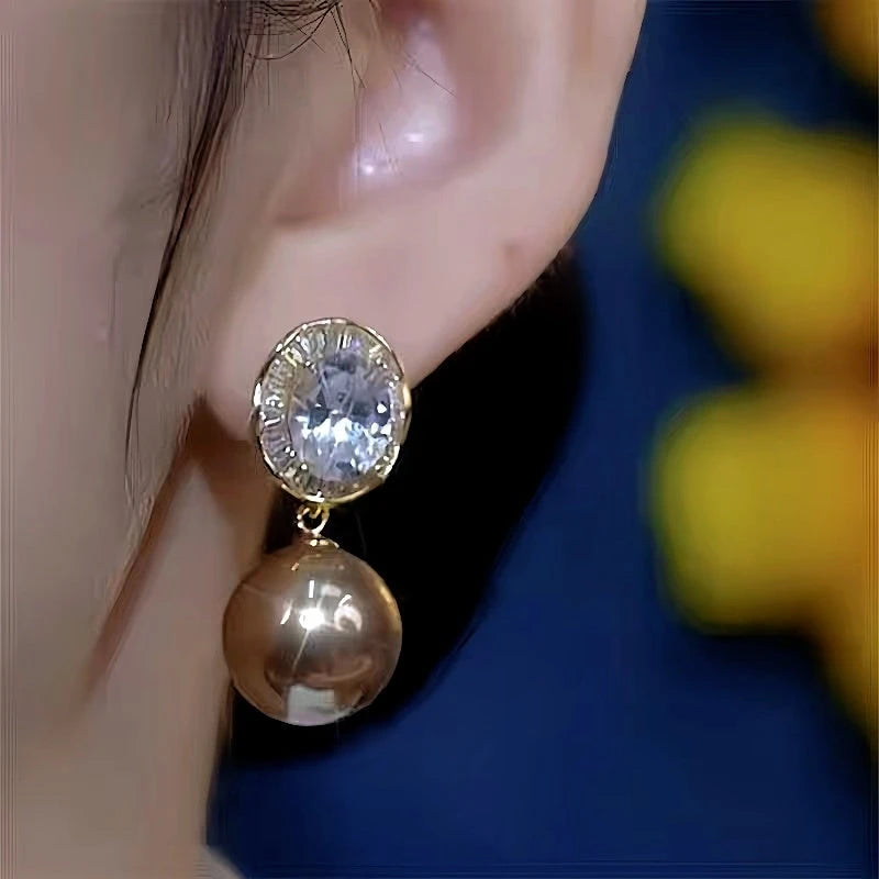 Close-up detail of the sparkling zircons and plating on the Pearl Drop Earrings