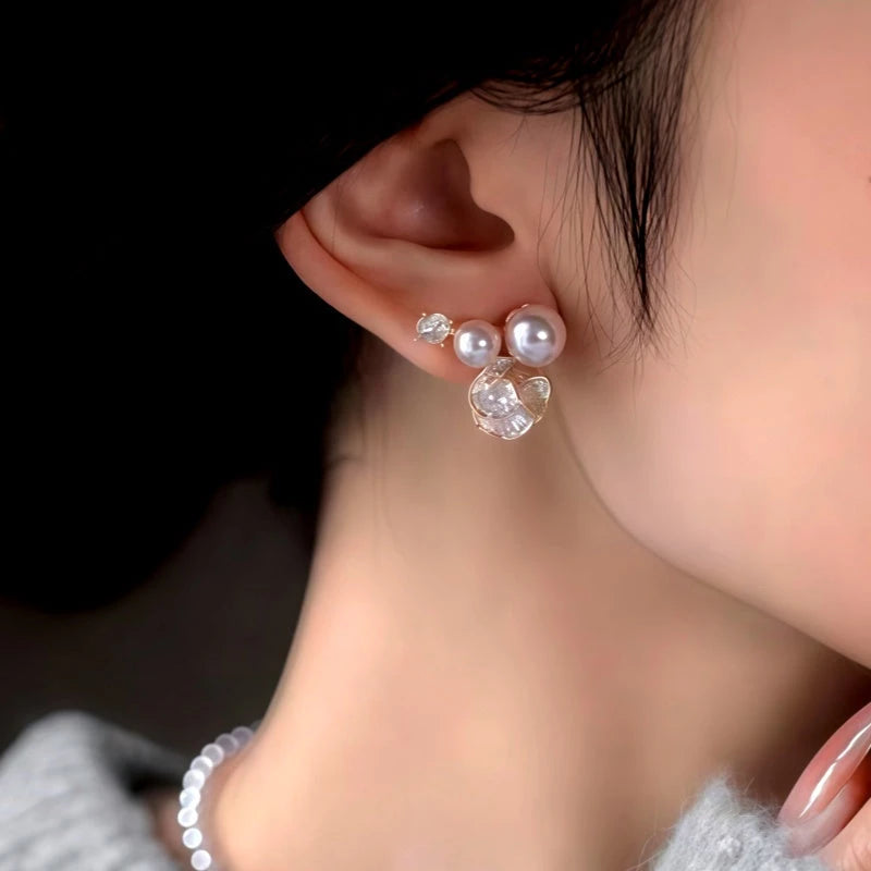 Model showcasing the dangle and style of the 14K Gold-Plated Zircon Diamond Pearl Flower Earrings