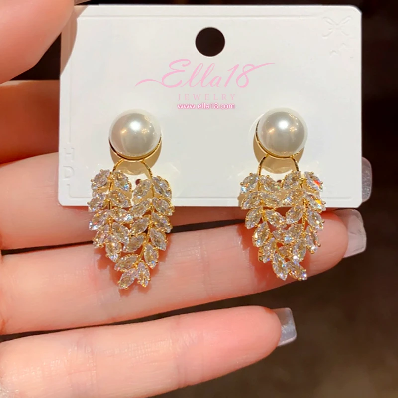 Model showcasing the dangle and style of the 14K Gold-Plated Zircon Diamond Pearl Leaf Earrings