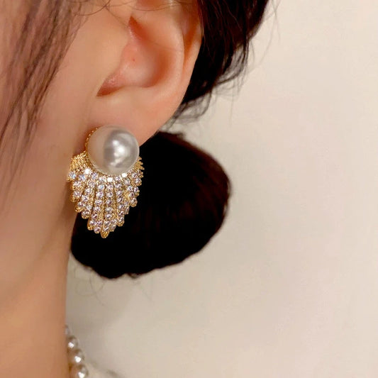 Model showcasing the dangle and style of the 14K Gold-Plated Zircon Diamond Pearl Tassel Earrings