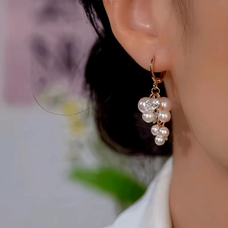 Model showcasing the dangle and style of the 14K Gold-Plated Zircon Diamond Pearl Tassel Earrings