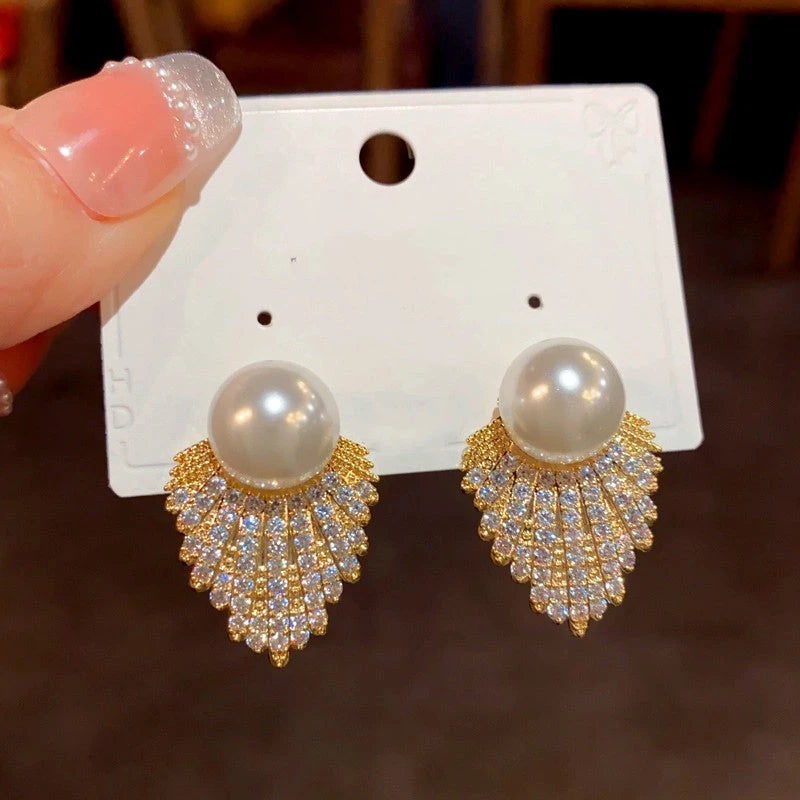 Angled view of the 14K Gold-Plated Zircon Diamond Pearl Tassel Earrings