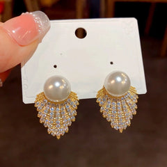 Angled view of the 14K Gold-Plated Zircon Diamond Pearl Tassel Earrings
