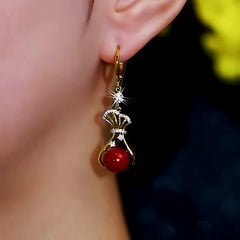 Angled view of the 14K Gold-Plated Zircon Diamond Red Lucky Bag Earrings