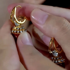 Model showcasing the dangle and style of the 14K Gold-Plated Zircon Diamond Red Pearl Earrings