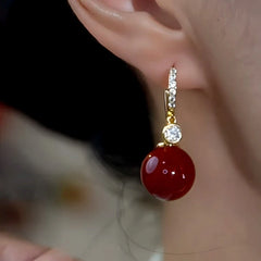 Close-up detail of the sparkling zircons and plating on the Red Pearl Earrings