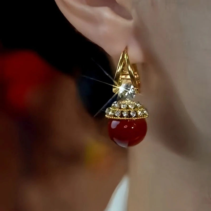 Angled view of the 14K Gold-Plated Zircon Diamond Red Pearl Earrings