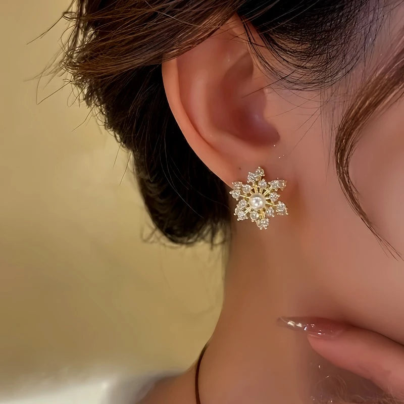 Close-up detail of the sparkling zircons and plating on the Rotating Snowflake Earrings