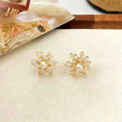 Angled view of the 14K Gold-Plated Zircon Diamond Rotating Snowflake Earrings