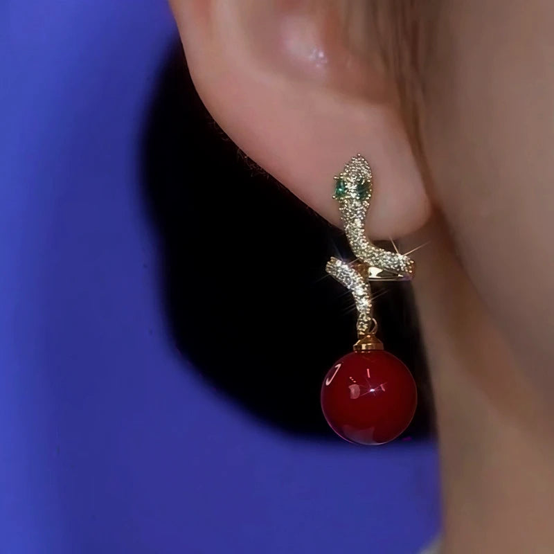 Model showcasing the dangle and style of the 14K Gold-Plated Zircon Diamond Snake Pearl Earrings