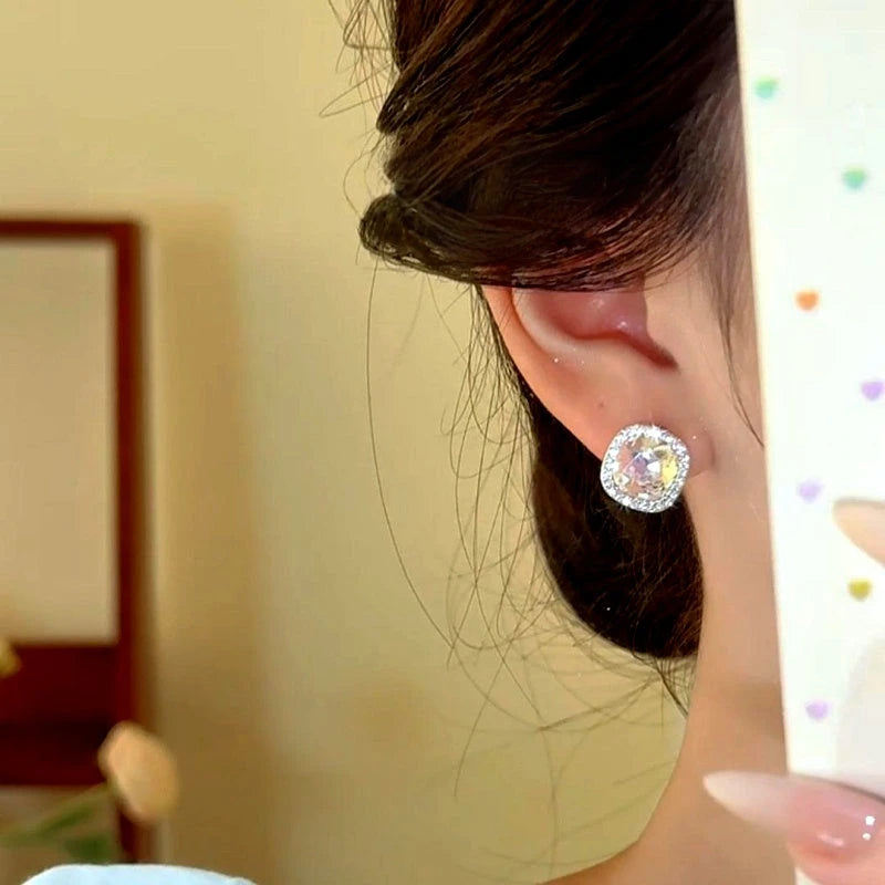 Model showcasing the dangle and style of the 14K Gold-Plated Zircon Diamond Stud Earrings