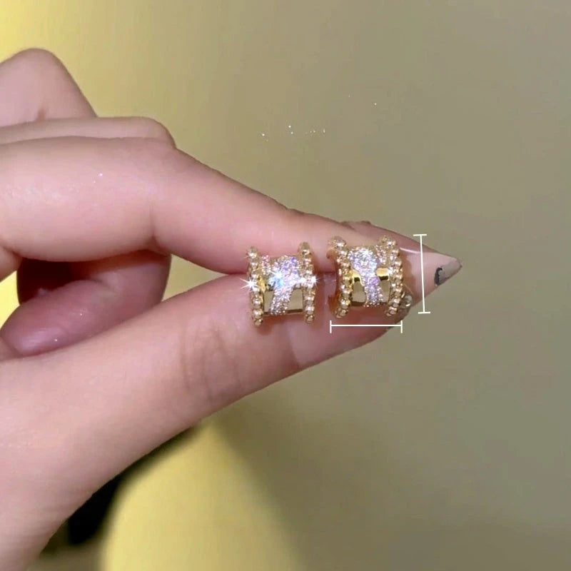 Model showcasing the dangle and style of the 14K Gold-Plated Zircon Diamond  Stud Earrings