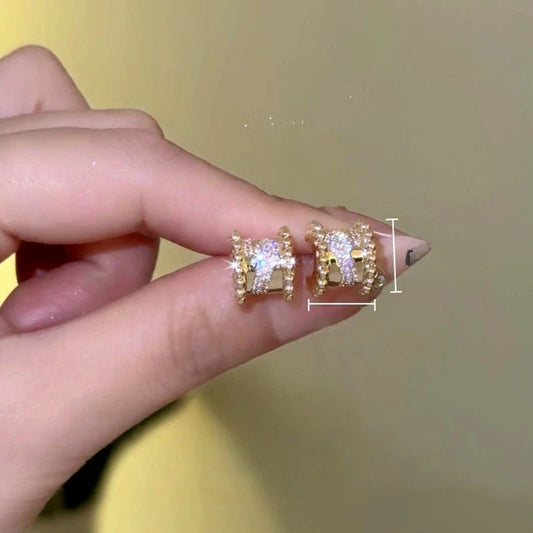 Model showcasing the dangle and style of the 14K Gold-Plated Zircon Diamond  Stud Earrings