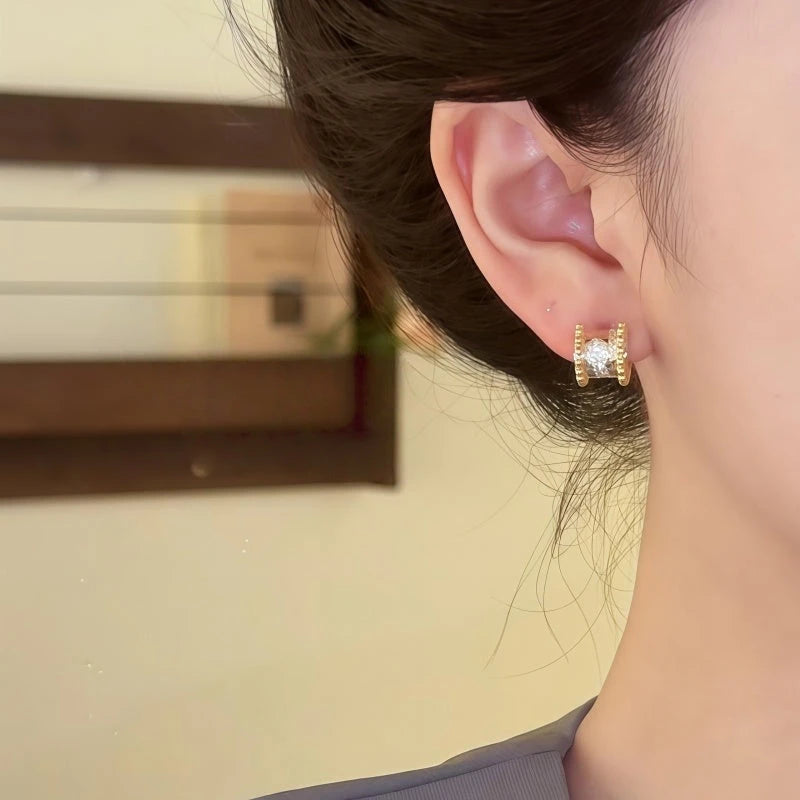 Close-up detail of the sparkling zircons and plating on the Gold Stud Earrings