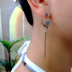 Model showcasing the dangle and style of the 14K Gold-Plated Zircon Diamond Sun Moon Star Tassel Earrrings