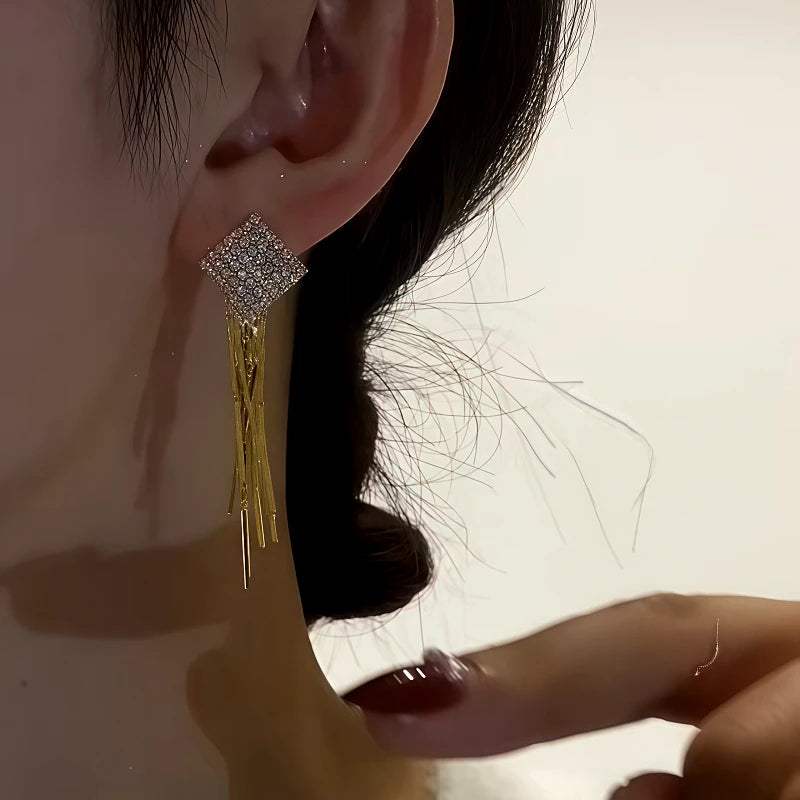 Model showcasing the dangle and style of the 14K Gold-Plated Zircon Diamond Tassel Earrings