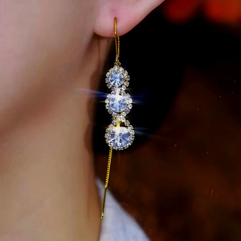 Model showcasing the dangle and style of the 14K Gold-Plated Zircon Diamond Tassel Threader Earrings