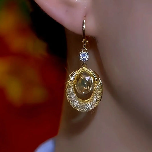 Model showcasing the dangle and style of the 14K Gold-Plated Zircon Diamond Water Drop Earrings