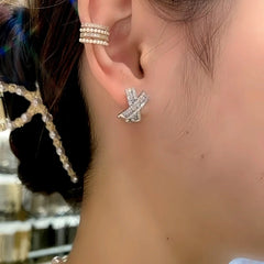 Model showcasing the dangle and style of the 14K Gold-Plated Zircon Diamond X-Shaped Elegant Studs