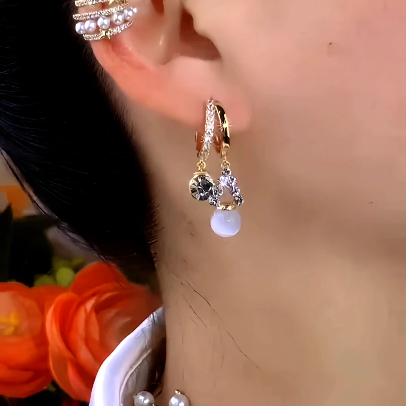 Model showcasing the dangle and style of the 14K Gold-Plated Zircon Double-Layer Cat's Eye Bead Earrings