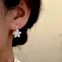 Model showcasing the dangle and style of the 14K Gold-Plated Zircon Double-Sided Flower Earrings