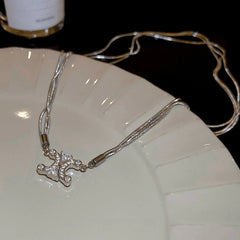 Close-up of the pendant and clasp on the Convertible Clover Necklace