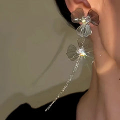 Model showcasing the dangle and style of the 14K Gold-Plated Zircon Double Flower Tassel Earrings