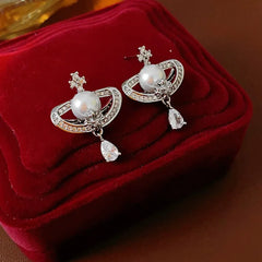 Model showcasing the dangle and style of the 14K Gold-Plated Zircon Drop Pearl Earrings