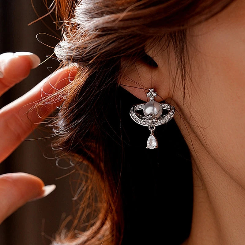Close-up detail of the sparkling zircons and plating on the Drop Pearl Earrings
