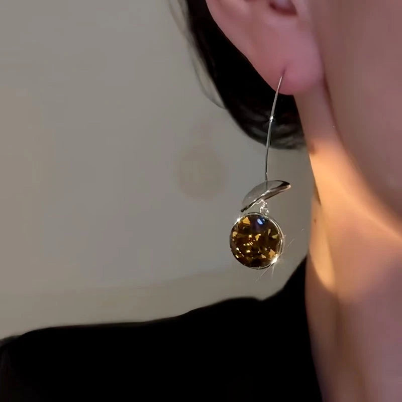 Model showcasing the dangle and style of the 14K Gold-Plated Zircon Ear Hook Earrings