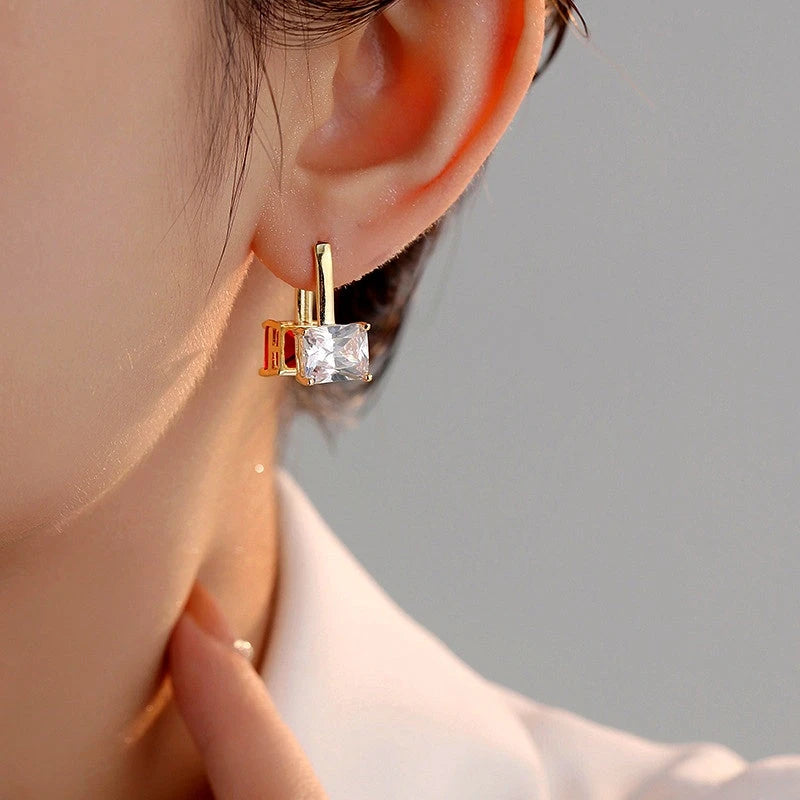 Model showcasing the dangle and style of the 14K Gold-Plated Zircon Earrings